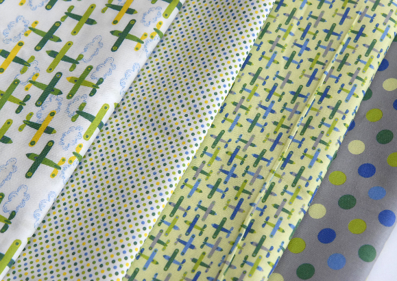 tissu motif petit avion vert